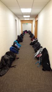 UMary students leave their backpacks in the hallway during mass.